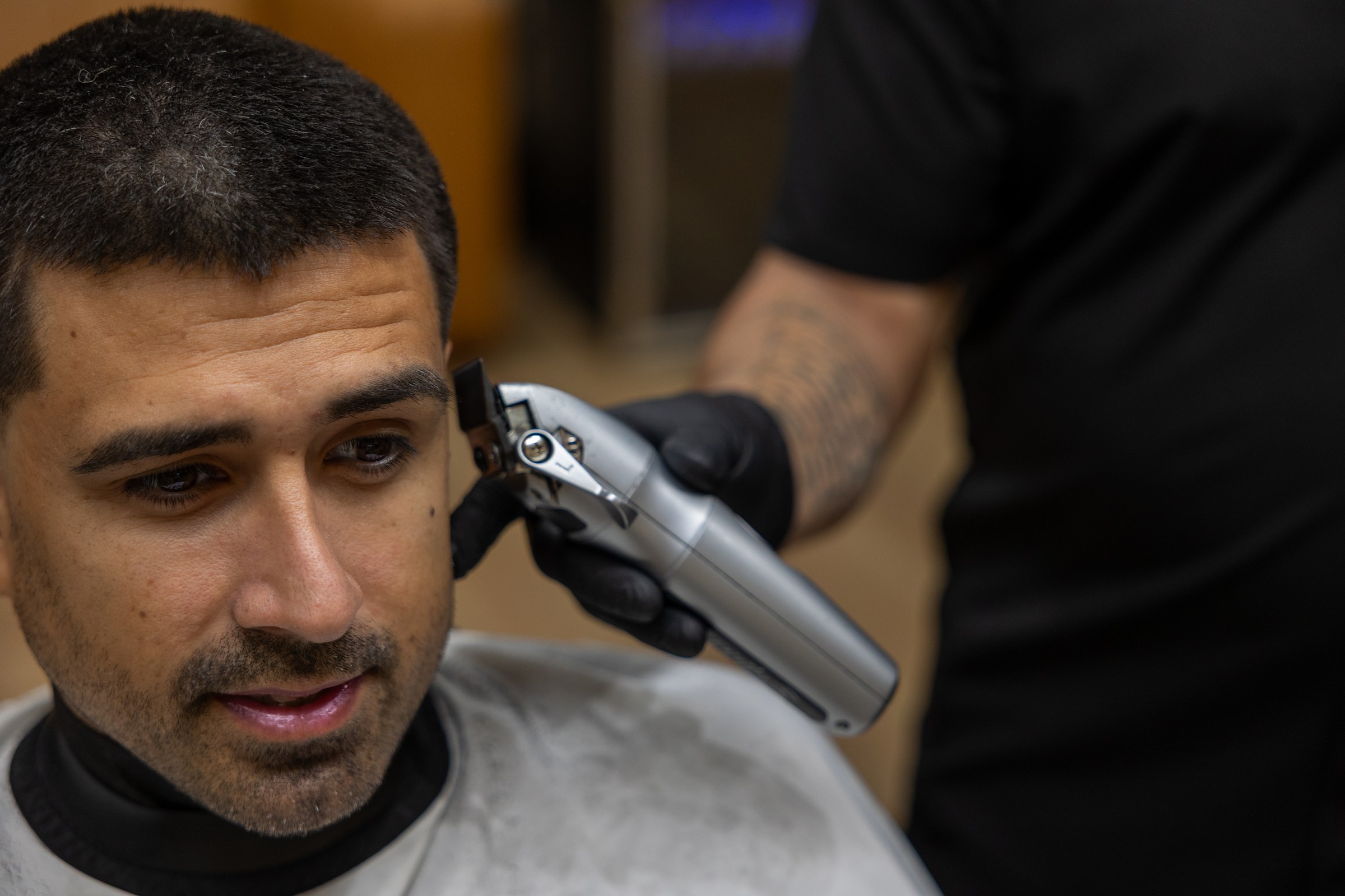 A Wellth barber giving a client a clipper cut