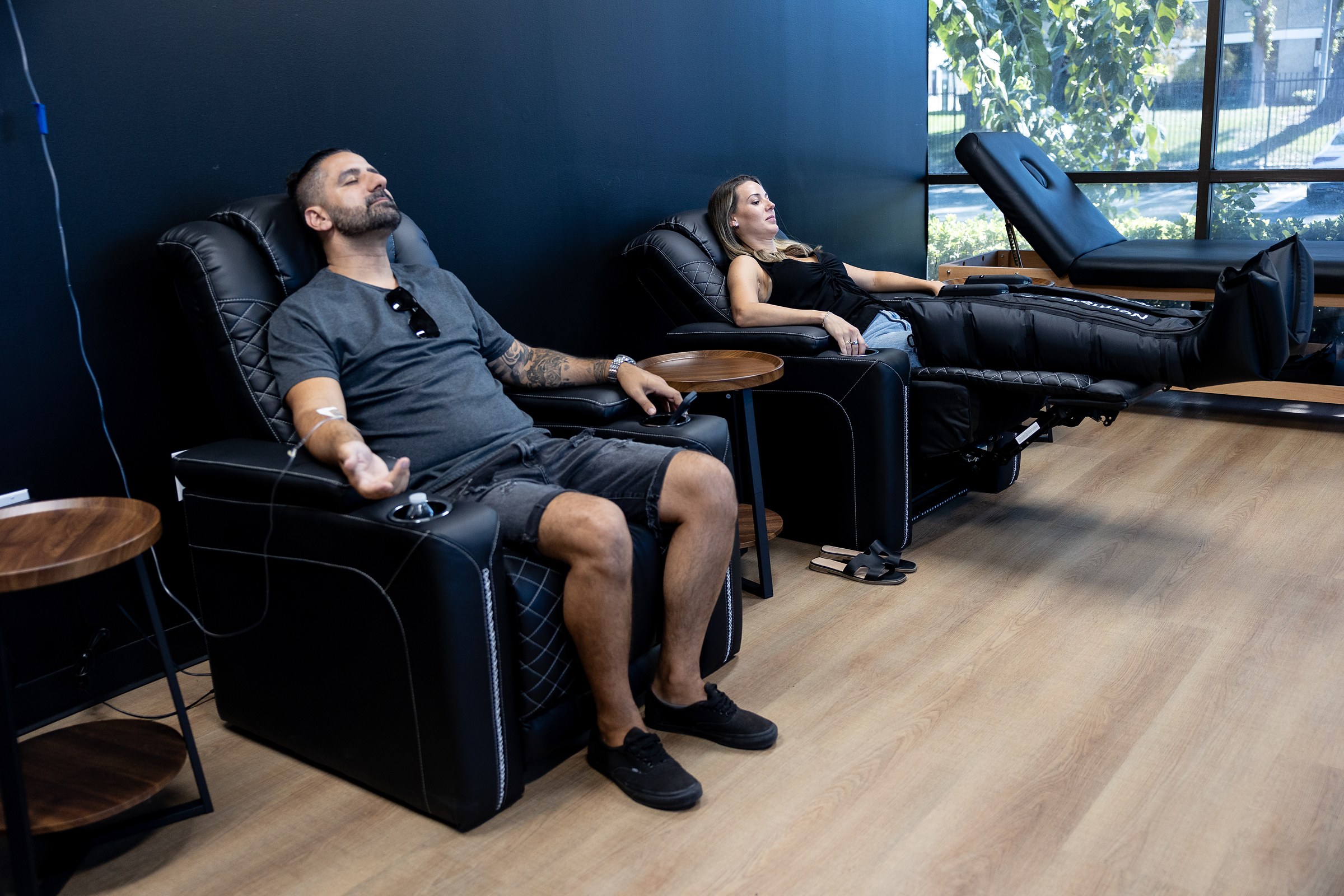 Members relaxing in recliners during IV therapy at Wellth