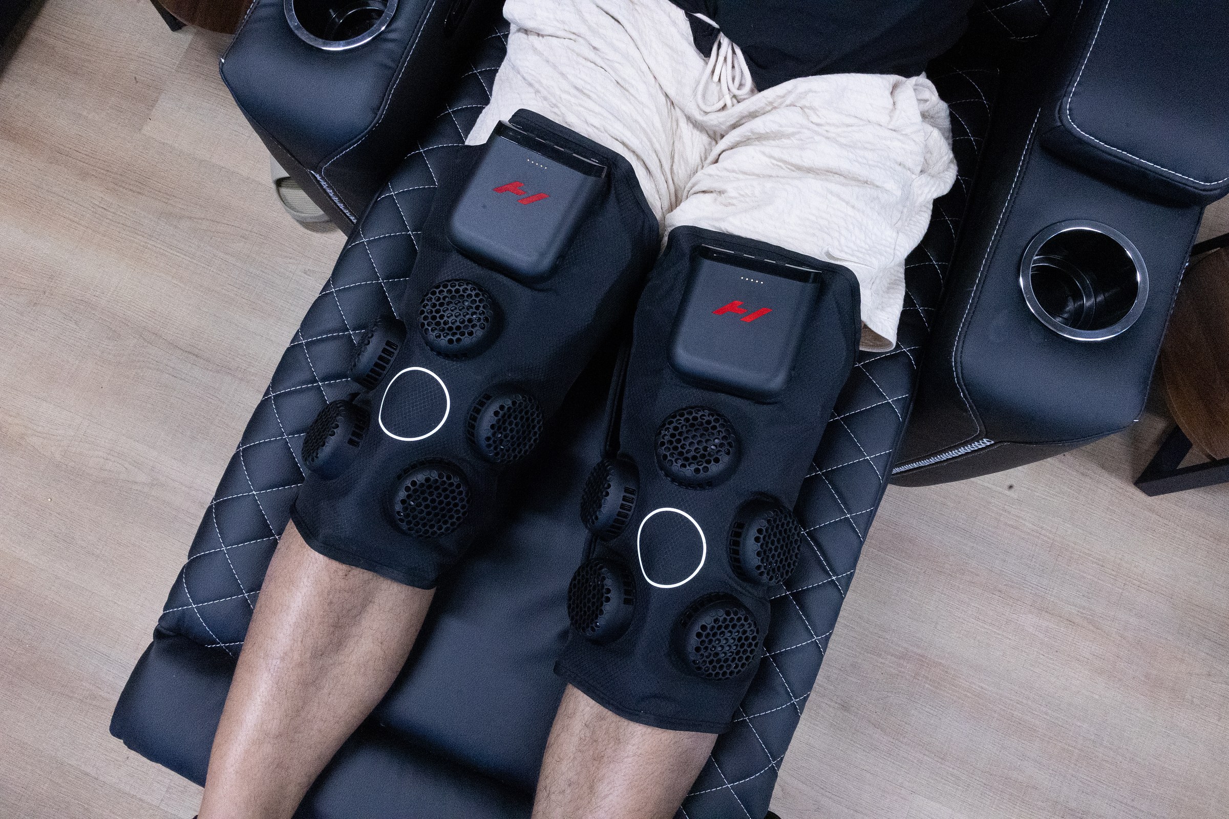 A member wearing Hyperice X 2 Knee wraps on both knees at Wellth